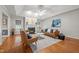 Open living room showcases a fireplace, tray ceiling, hardwood floors, and lots of natural light at 2917 Kesler Trl, Mebane, NC 27302