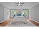 Main bedroom with hardwood floors, white bedding, neutral walls and a ceiling fan at 2917 Kesler Trl, Mebane, NC 27302