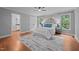 Bedroom features hardwood floors, white bedding, and ensuite bathroom access at 2917 Kesler Trl, Mebane, NC 27302
