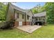 A side exterior view of a home with a basement door, patio and deck on the back of the house at 2917 Kesler Trl, Mebane, NC 27302