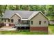 A back exterior view of a home featuring a deck, a brick foundation and vinyl siding at 2917 Kesler Trl, Mebane, NC 27302