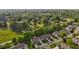 An aerial view of townhomes showcases lush green surroundings with mature trees and manicured lawns at 3027 Maple Ave # M2, Burlington, NC 27215
