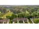 An aerial view of townhomes showcases lush green surroundings with mature trees and manicured lawns at 3027 Maple Ave # M2, Burlington, NC 27215