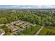 An aerial view captures a community surrounded by lush trees near a main road at 3027 Maple Ave # M2, Burlington, NC 27215