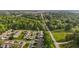 An aerial view features a community nestled among green trees, and manicured lawns at 3027 Maple Ave # M2, Burlington, NC 27215