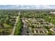 An aerial view captures a community nestled among green trees, and manicured lawns, near a main road at 3027 Maple Ave # M2, Burlington, NC 27215