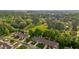 An aerial view shows the neighborhood's mature trees, green space, and well-maintained townhomes at 3027 Maple Ave # M2, Burlington, NC 27215