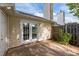 View of the house's back exterior with a small patio and fenced backyard at 3027 Maple Ave # M2, Burlington, NC 27215