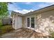 View of the house's back exterior with a small patio and fenced backyard at 3027 Maple Ave # M2, Burlington, NC 27215