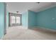 A bedroom with carpeted floors and natural light, featuring a neutral color scheme, creates a versatile space at 3027 Maple Ave # M2, Burlington, NC 27215