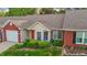 Charming brick and siding home with landscaped front yard and red front door at 3027 Maple Ave # M2, Burlington, NC 27215