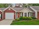 Charming brick and siding home with a well-manicured front lawn and attached garage at 3027 Maple Ave # M2, Burlington, NC 27215