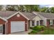Charming brick and siding home with a well-manicured front lawn and an attached garage at 3027 Maple Ave # M2, Burlington, NC 27215