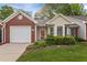 Charming brick and siding home with a well-manicured front lawn and attached garage at 3027 Maple Ave # M2, Burlington, NC 27215