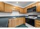 The kitchen features wooden cabinets and modern appliances at 3027 Maple Ave # M2, Burlington, NC 27215