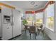 Bright eat-in kitchen with a bay window, modern lighting, and stainless steel refrigerator at 3027 Maple Ave # M2, Burlington, NC 27215
