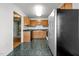 Functional kitchen with stainless refrigerator and tiled floors at 3027 Maple Ave # M2, Burlington, NC 27215