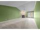 The open living room features a fireplace, a ceiling fan and access to the exterior through glass patio doors at 3027 Maple Ave # M2, Burlington, NC 27215