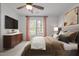 Main bedroom with a ceiling fan, TV, and large window at 3027 Maple Ave # M2, Burlington, NC 27215