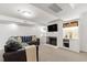 Cozy basement with a fireplace, built-in shelves, and comfortable seating area for relaxation and entertainment at 3028 Rothgeb Dr, Raleigh, NC 27609