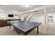 Finished basement with a ping pong table, neutral carpet, and a comfortable seating area at 3028 Rothgeb Dr, Raleigh, NC 27609