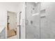 Elegant bathroom featuring glass shower with marble tile, neutral color palette, and gold hardware at 3028 Rothgeb Dr, Raleigh, NC 27609