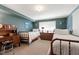 Comfortable bedroom with two beds, a desk, and dresser with neutral color palette at 3028 Rothgeb Dr, Raleigh, NC 27609