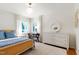 Bright bedroom with natural light featuring beautiful white trim, curtains, neutral carpet and furnishings at 3028 Rothgeb Dr, Raleigh, NC 27609