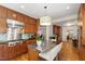 Well-equipped kitchen with stainless steel appliances, breakfast bar, and custom cabinetry at 3028 Rothgeb Dr, Raleigh, NC 27609