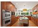 Gourmet kitchen featuring stainless steel appliances, island with seating, and abundant natural light at 3028 Rothgeb Dr, Raleigh, NC 27609