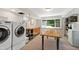 Functional laundry room with washer, dryer, cabinets, and ample workspace at 3028 Rothgeb Dr, Raleigh, NC 27609