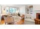 Cozy living room with a fireplace, built-in shelving, and lots of natural light at 3028 Rothgeb Dr, Raleigh, NC 27609