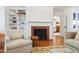 Living room with a brick fireplace and built-in shelving at 3028 Rothgeb Dr, Raleigh, NC 27609