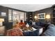 Cozy living room with dark walls, plush seating, and built-in bookshelves at 3028 Rothgeb Dr, Raleigh, NC 27609