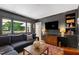 Comfortable living room with dark accent wall, stylish furnishings, and ample natural light at 3028 Rothgeb Dr, Raleigh, NC 27609