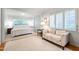 Serene main bedroom features neutral colors, sitting area, and large windows with plantation shutters at 3028 Rothgeb Dr, Raleigh, NC 27609