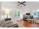 Cozy office space with hardwood floors, desk, comfortable couch, and ample natural light at 3028 Rothgeb Dr, Raleigh, NC 27609