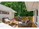Inviting outdoor patio space with wicker furniture and a wooden deck for relaxing and enjoying the outdoors at 3028 Rothgeb Dr, Raleigh, NC 27609