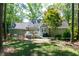 Spacious backyard featuring wooden swing, lush greenery, patio, and outdoor seating at 305 Monterey Ct, Benson, NC 27504