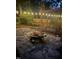 Backyard with fire pit and swing at night at 305 Monterey Ct, Benson, NC 27504