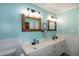 Stylish bathroom with double vanity, modern lighting, and framed mirrors at 305 Monterey Ct, Benson, NC 27504