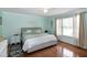 Comfortable bedroom with a ceiling fan, natural light, and decorative bedside tables at 305 Monterey Ct, Benson, NC 27504