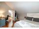 Lovely bedroom with a desk, plush bed, hardwood floors, and an open doorway at 305 Monterey Ct, Benson, NC 27504