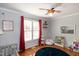 Bedroom with crib, baseball decor, dark rug, and a ceiling fan at 305 Monterey Ct, Benson, NC 27504
