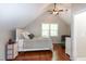 Cozy bedroom with plush bed, ceiling fan, hardwood floors and natural lighting at 305 Monterey Ct, Benson, NC 27504