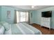 Inviting bedroom with a ceiling fan, natural light, and a modern television at 305 Monterey Ct, Benson, NC 27504