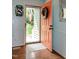 Bright entryway features a wood floor, a view of the front yard, and a pop of color from the front door at 305 Monterey Ct, Benson, NC 27504
