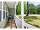 Cozy front porch with chairs, offering a relaxing outdoor space with views of the surrounding trees and lawn at 305 Monterey Ct, Benson, NC 27504