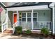 Welcoming front porch with chairs, a bright front door, and fresh landscaping around the front of the home at 305 Monterey Ct, Benson, NC 27504