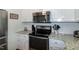 Well-lit kitchen featuring granite countertops, stainless steel appliances, and white subway tile backsplash at 305 Monterey Ct, Benson, NC 27504